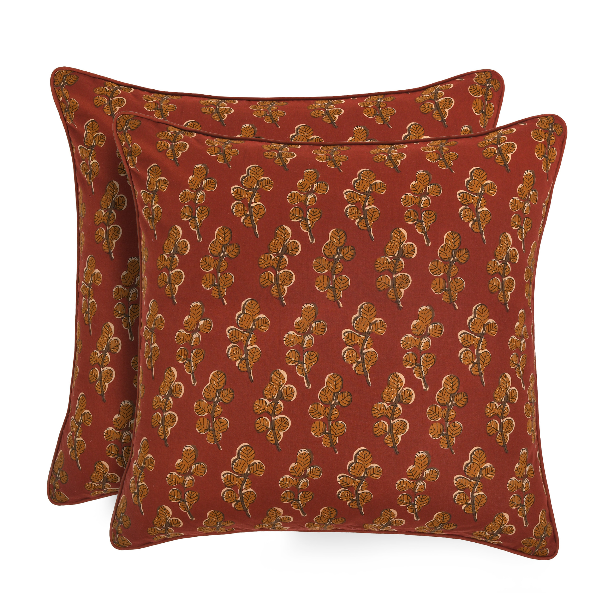 Two red pillows with gold floral patterns on a white background