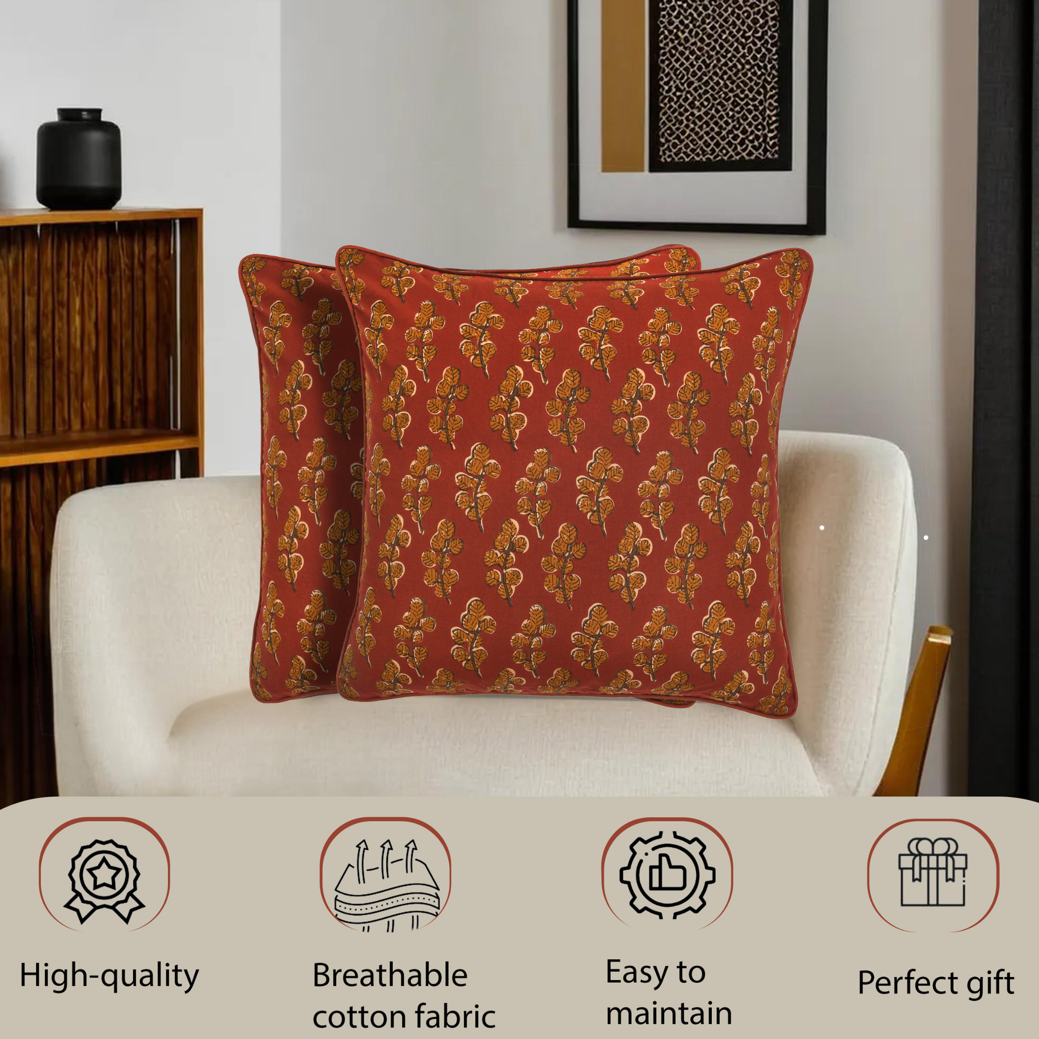 Two red patterned pillows on a white armchair with product features displayed below.
