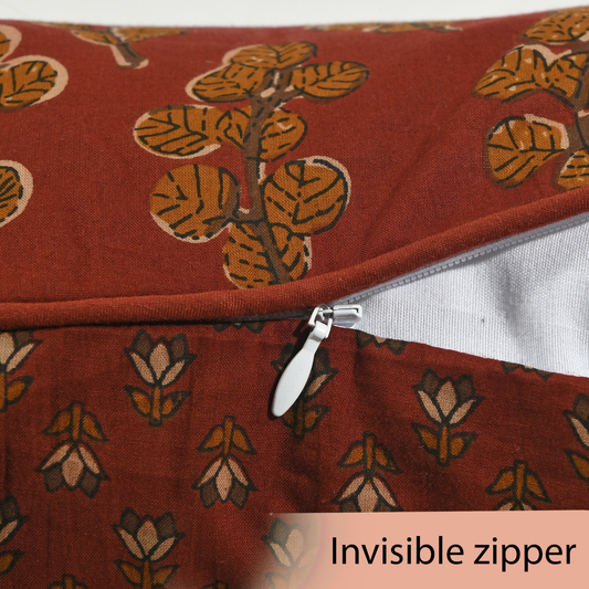 Red fabric with leaf pattern and an invisible zipper on a white background