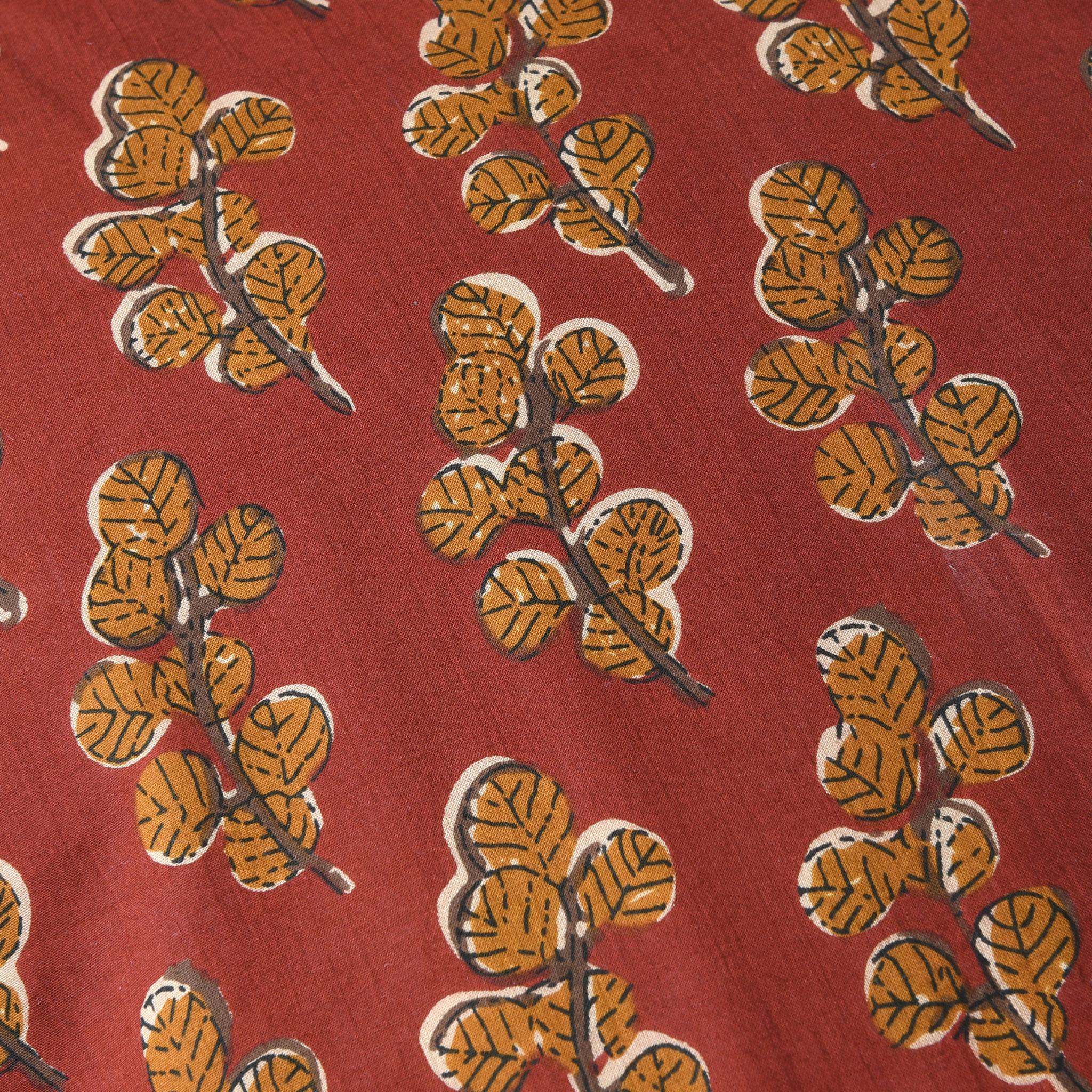 Pattern of orange leaves on a red background