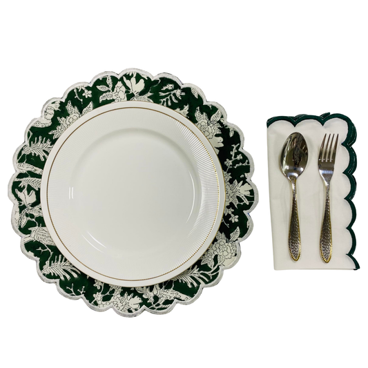 White plate with green floral rim, silver cutlery, and napkin on a white background