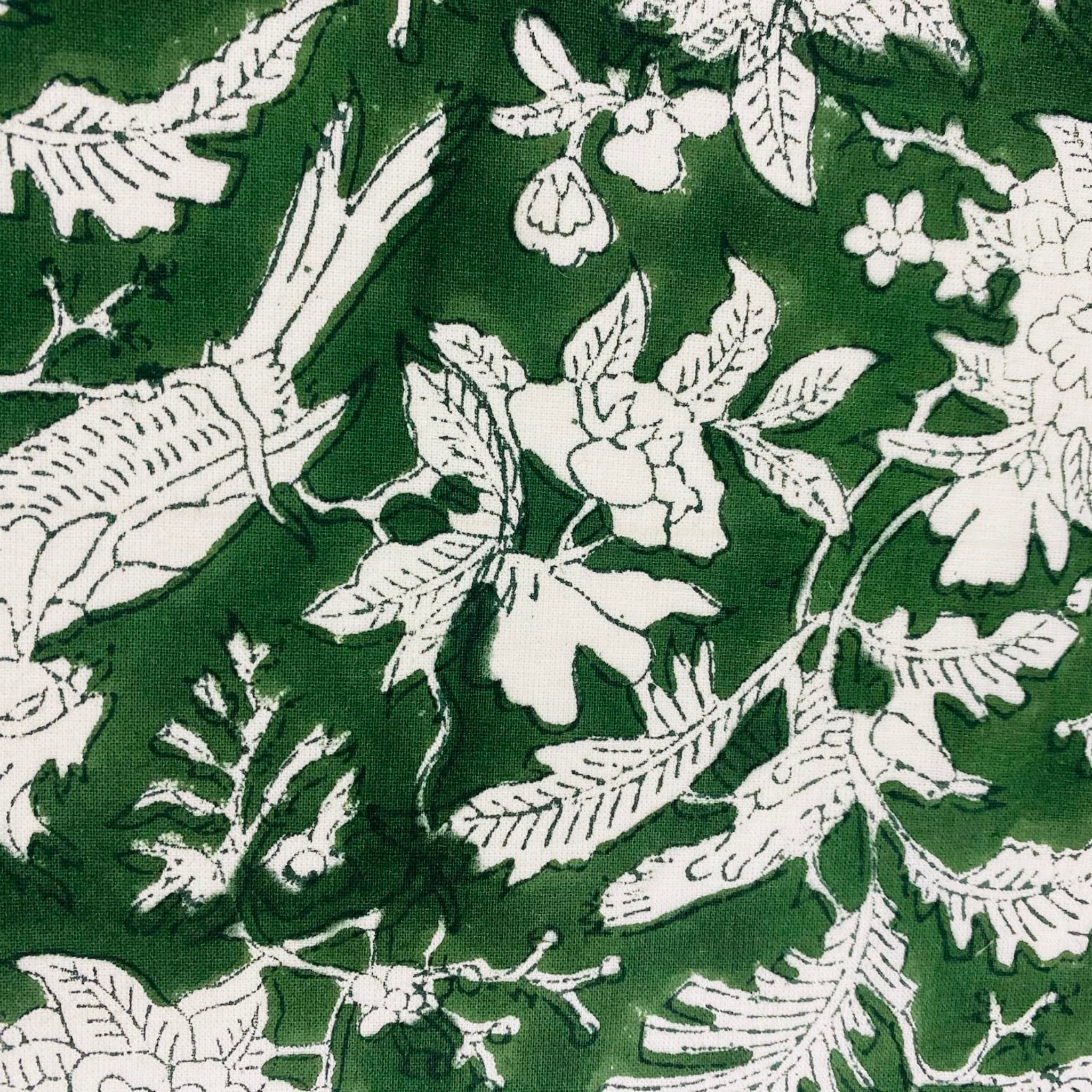 White floral and leaf pattern on a green background
