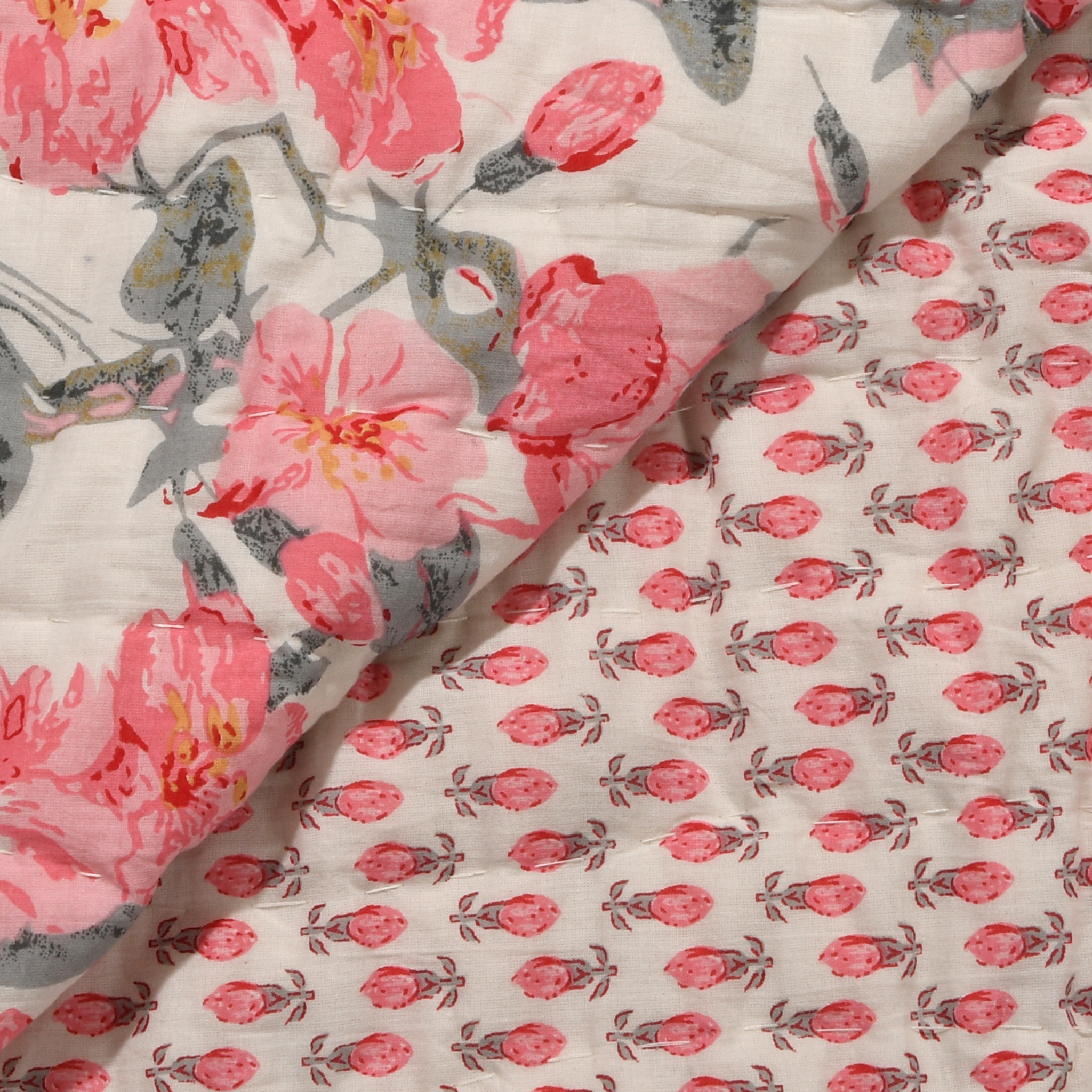 Floral fabric with pink flowers and green leaves on a white background