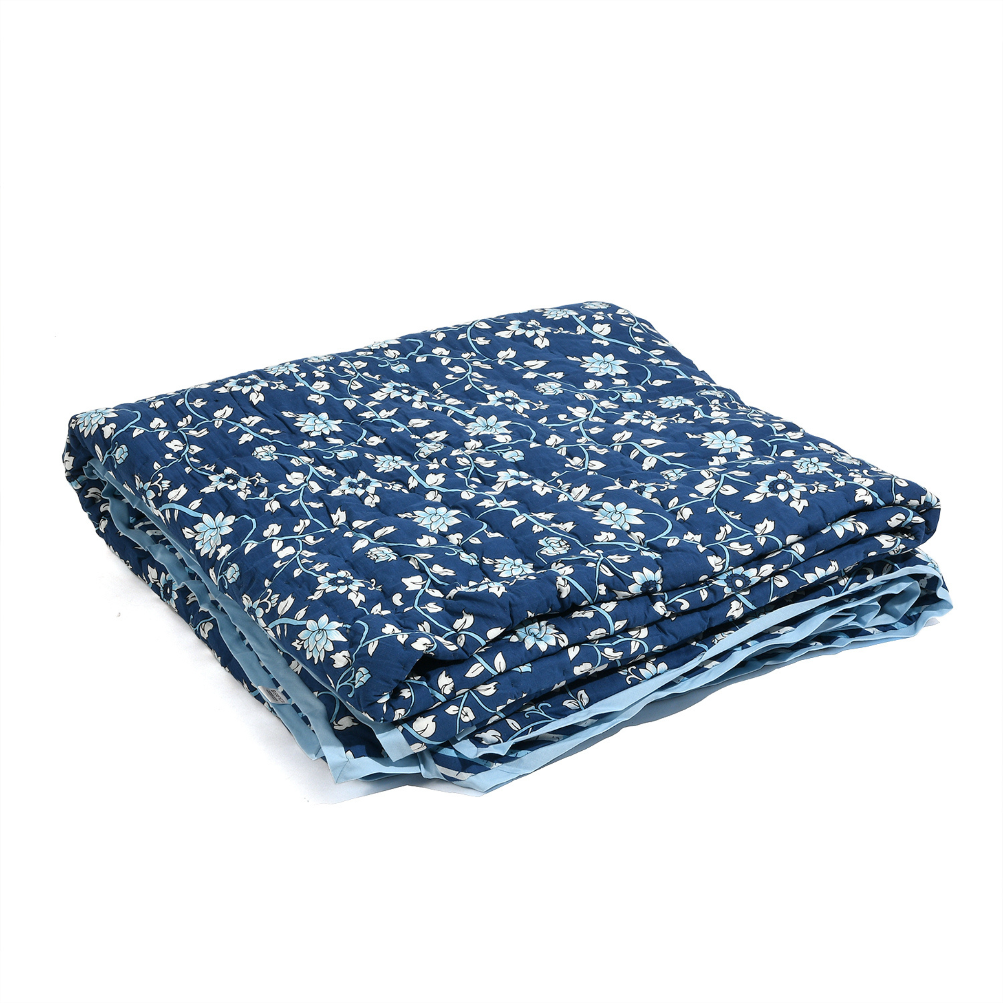 Folded blue fabric with white floral pattern on a white background