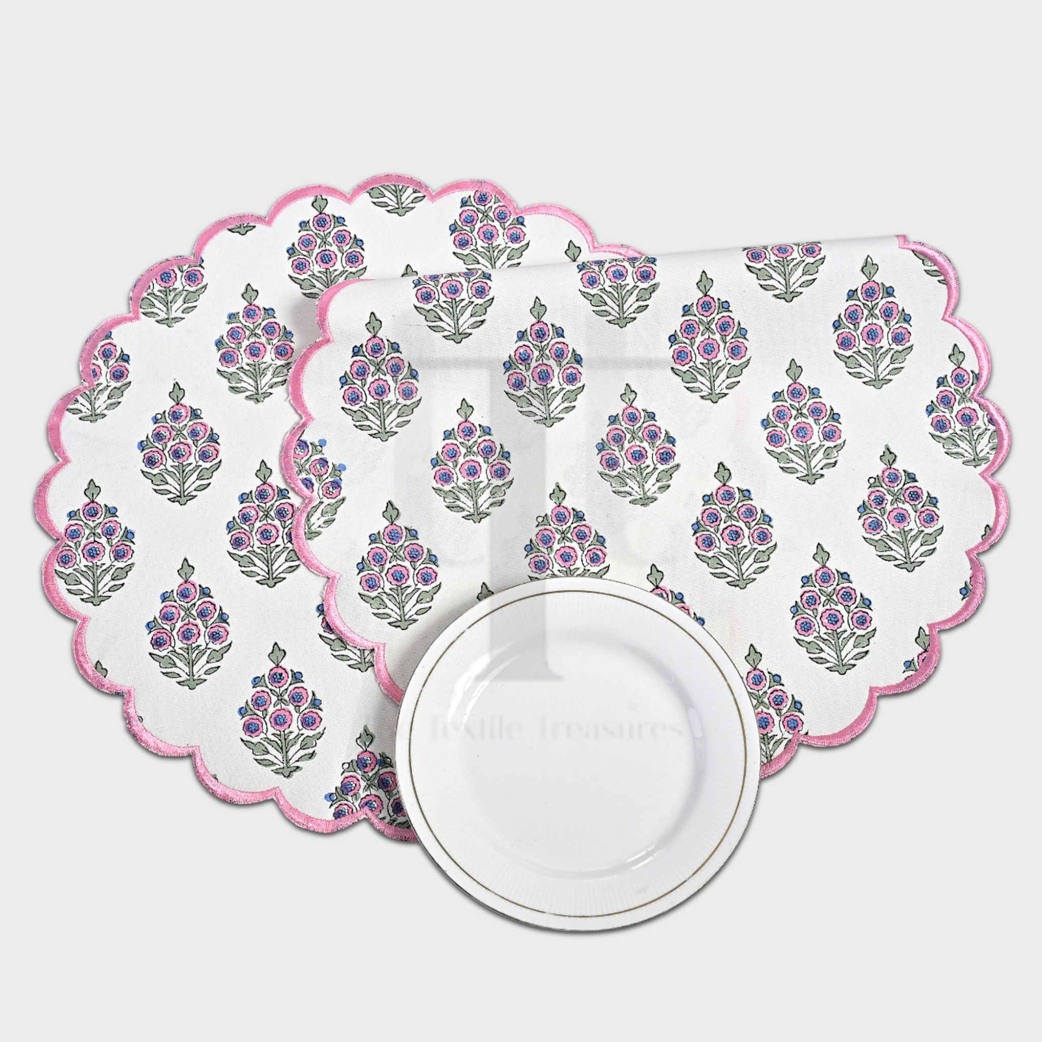Set of floral placemats with a scalloped edge on a white background