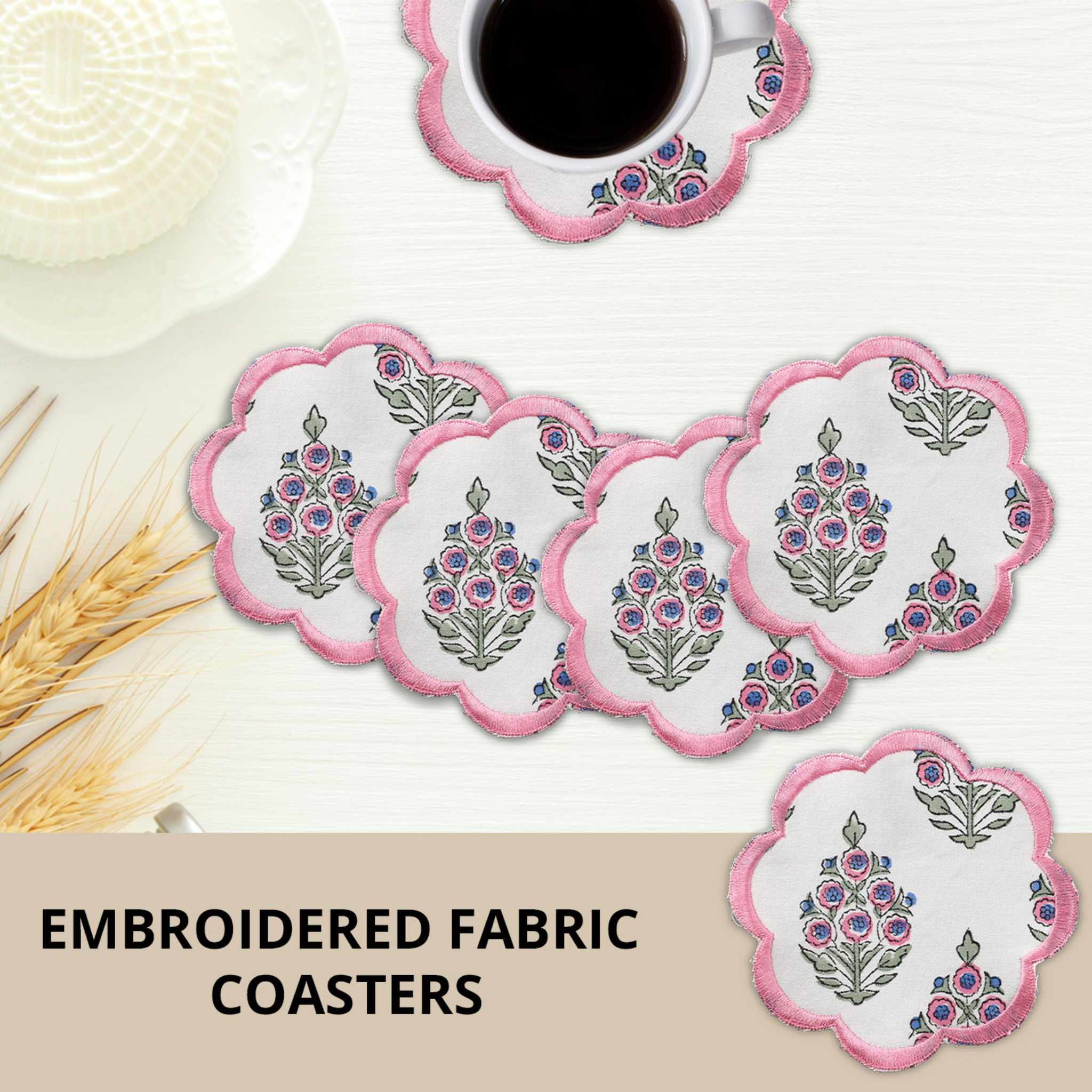 Set of embroidered fabric coasters with a cup of coffee on a white surface.
