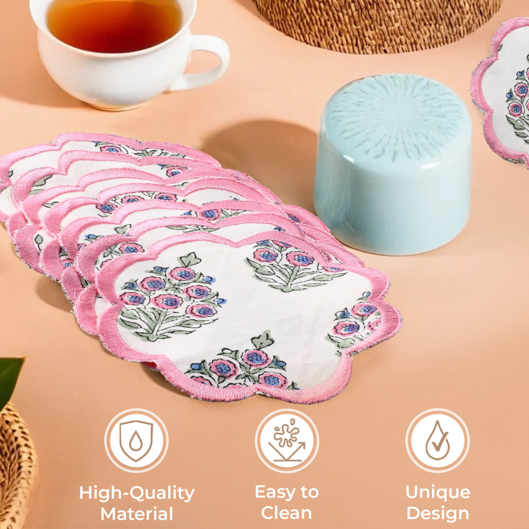 Set of floral coasters on a table with tea and a candle, featuring icons for high-quality material, easy to clean, and unique design.