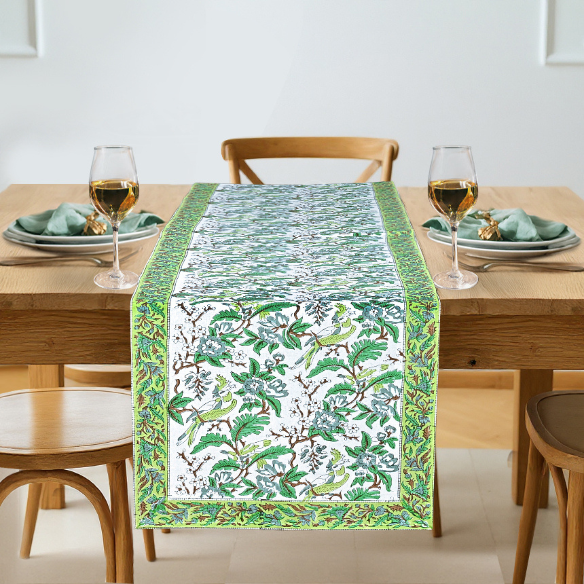 Table setting with a decorative table runner on a wooden table.