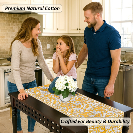 Family in a kitchen with a table runner featuring white flowers.