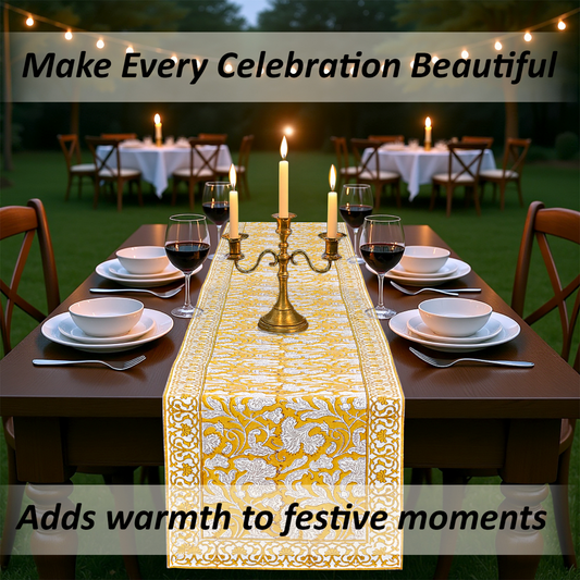 Dining table set for a celebration with a decorative table runner, candles, and wine glasses.