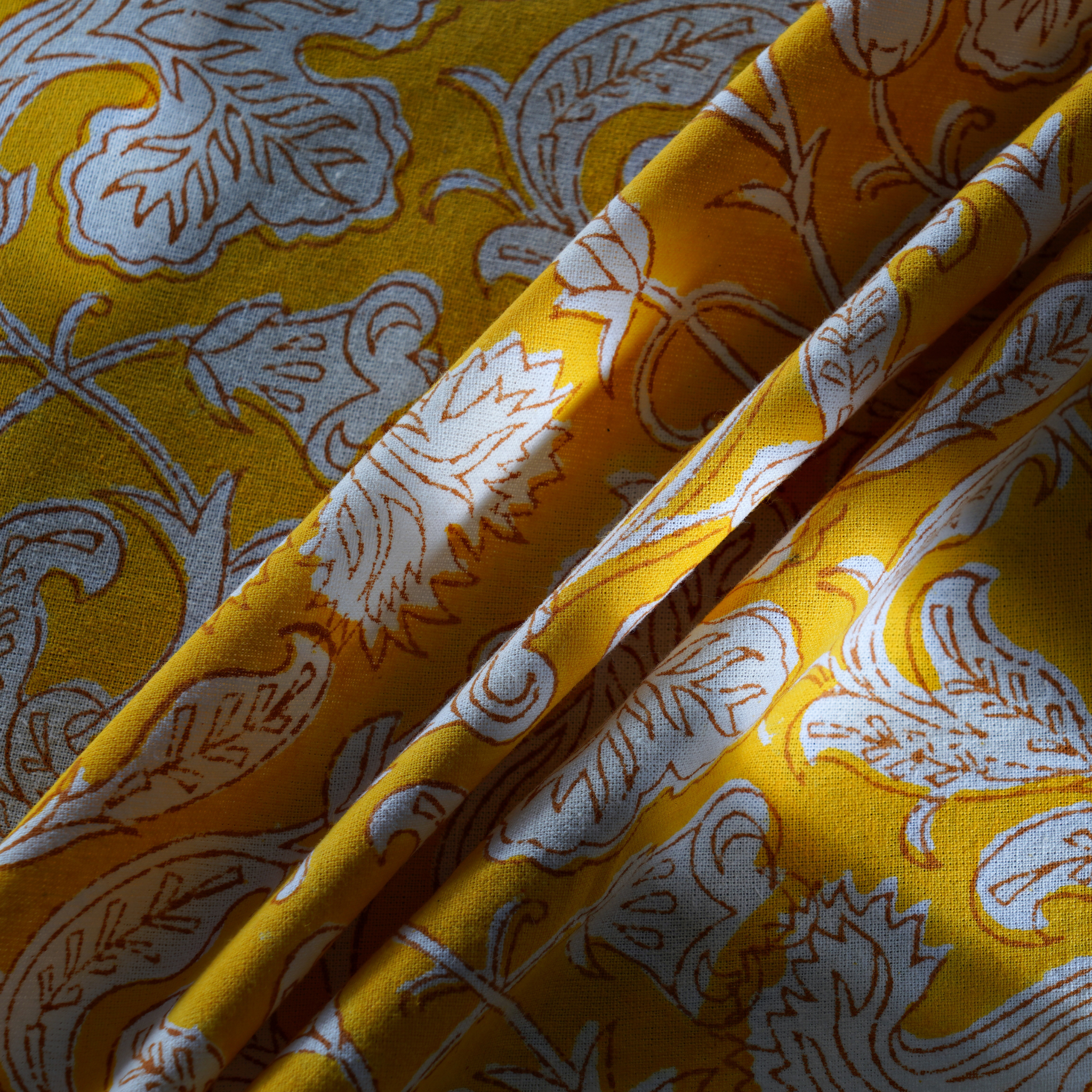 Yellow fabric with white floral patterns