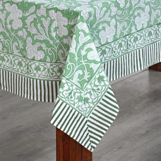 Green and white patterned tablecloth on a wooden table