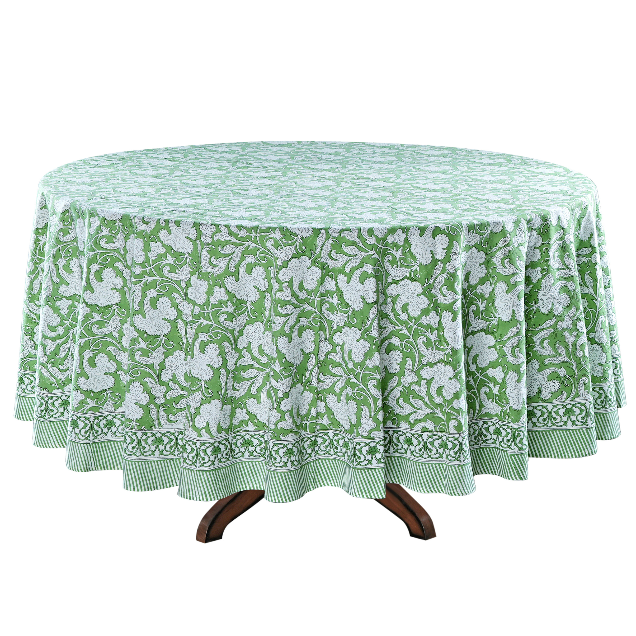 Green and white floral patterned tablecloth on a round table