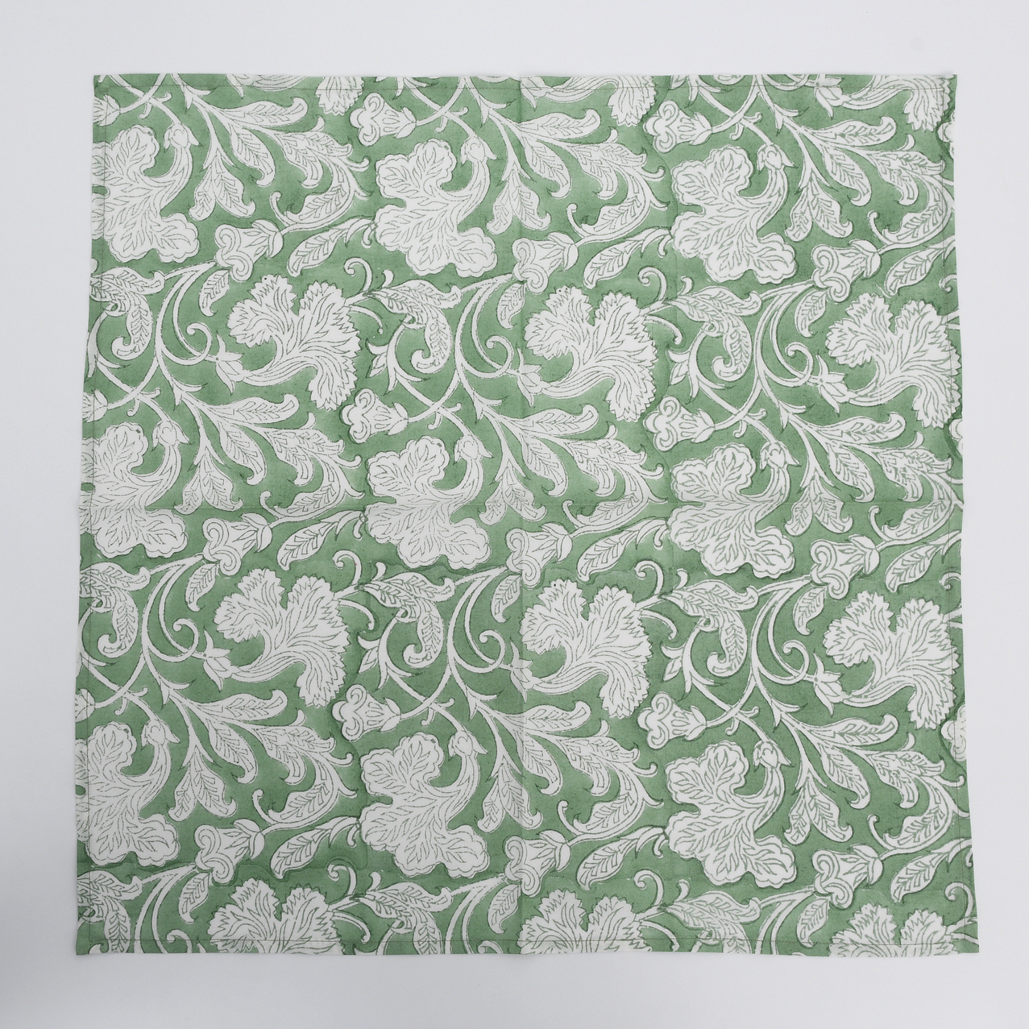 Floral patterned fabric swatch on a green background