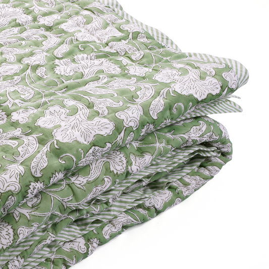 Green floral patterned fabric on a white background