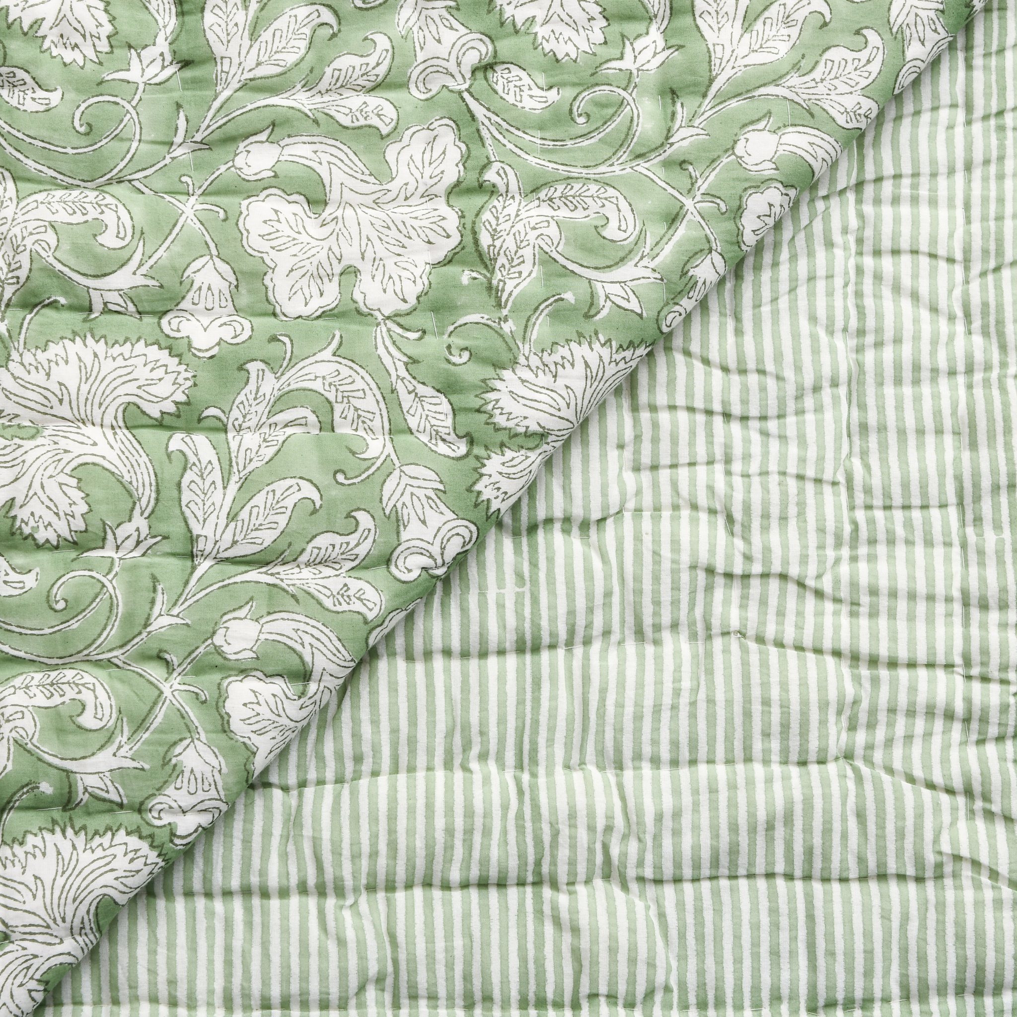 Two green textured fabrics with different patterns on a white background