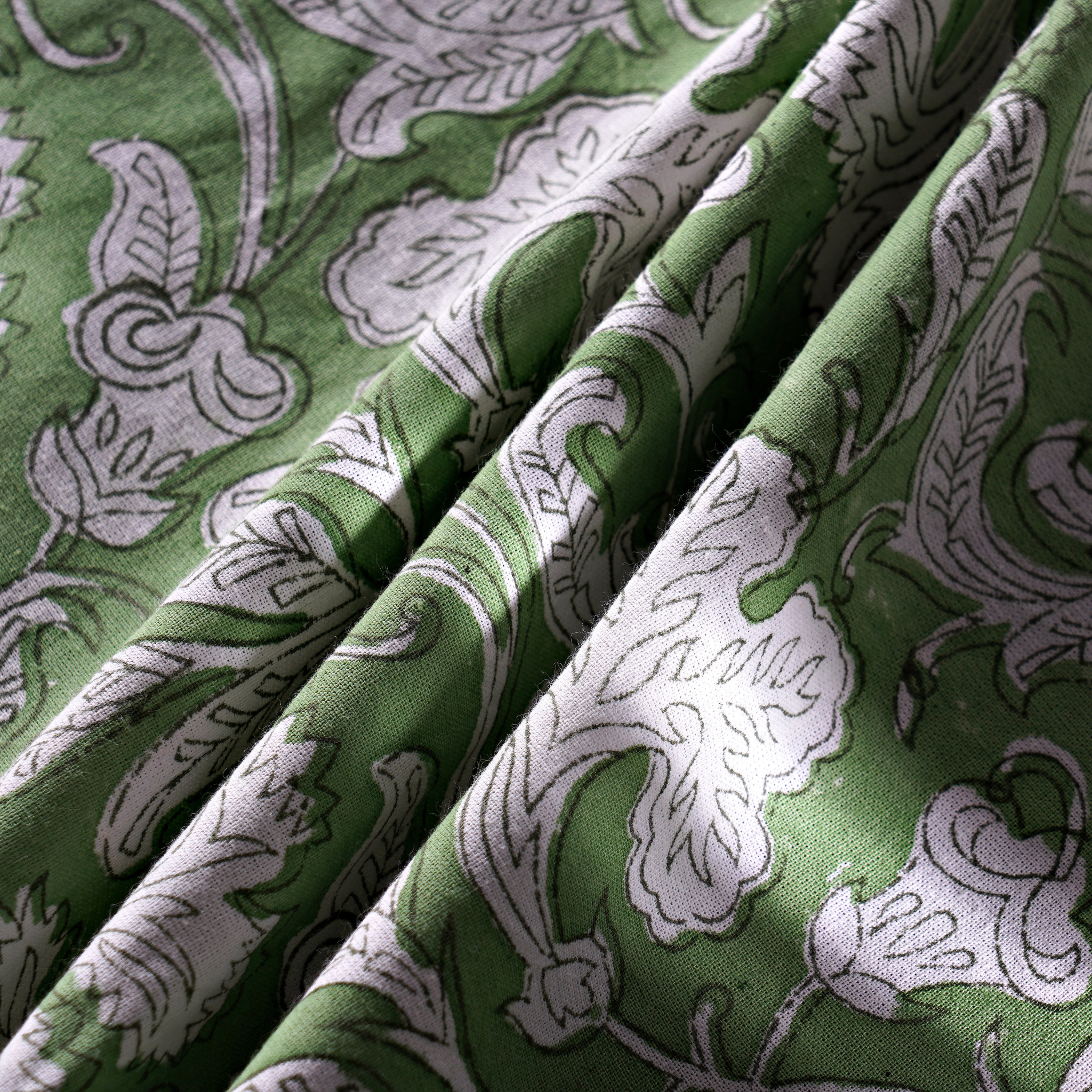 Green fabric with white floral patterns