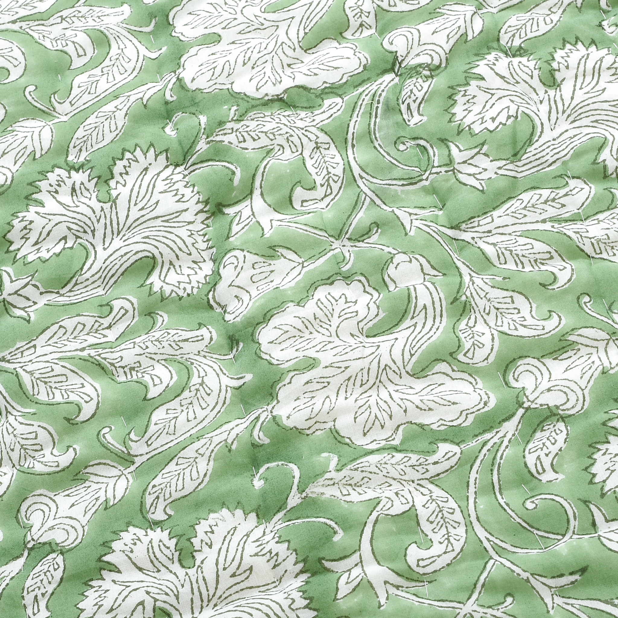 White floral pattern on a green background