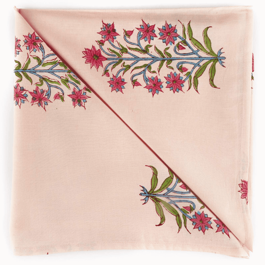 Pink fabric with floral embroidery on a white background