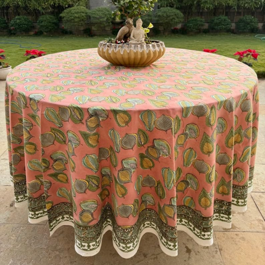 Round table with a patterned tablecloth outdoors on a patio