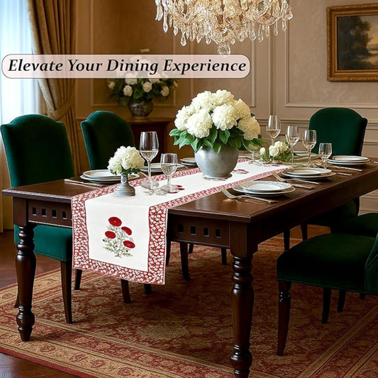 Dining room with a table set for dinner, flowers, and a chandelier.