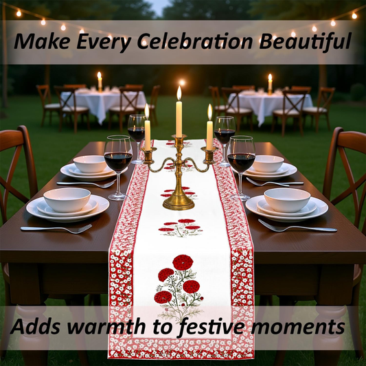 Dining table set with a floral table runner, candles, and wine glasses outdoors.