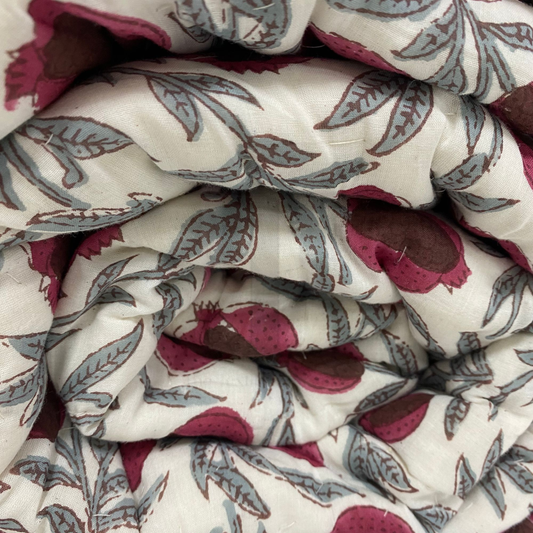 Close-up of patterned fabric with pink and gray design on a white background