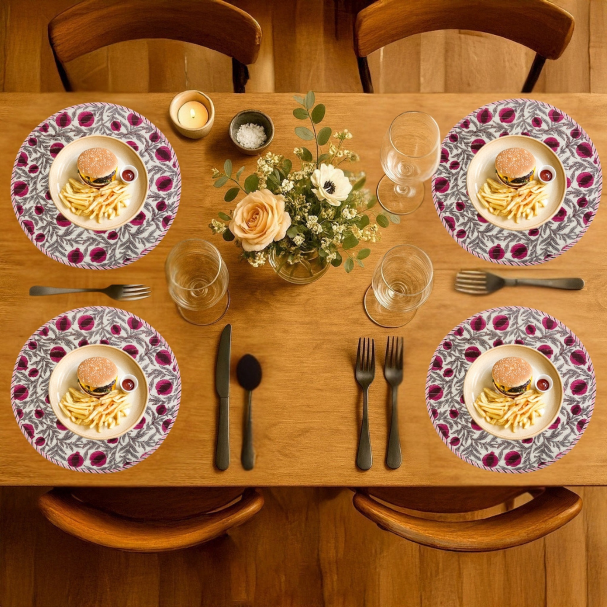Dining table set with plates, cutlery, and a centerpiece on a wooden table.