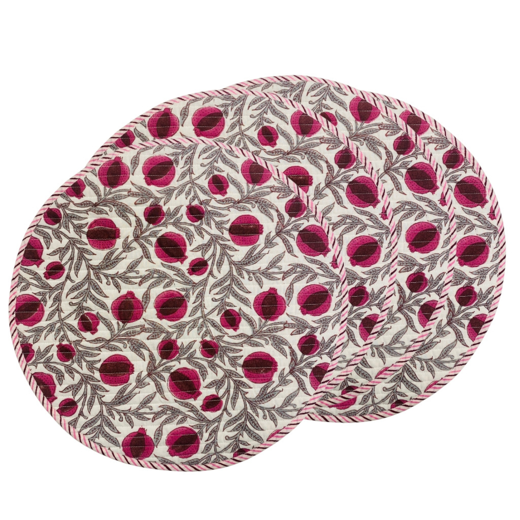 Two round placemats with a pink and gray pattern on a white background
