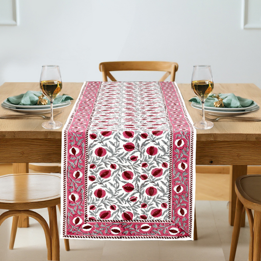 Table runner with red floral pattern on a dining table setting