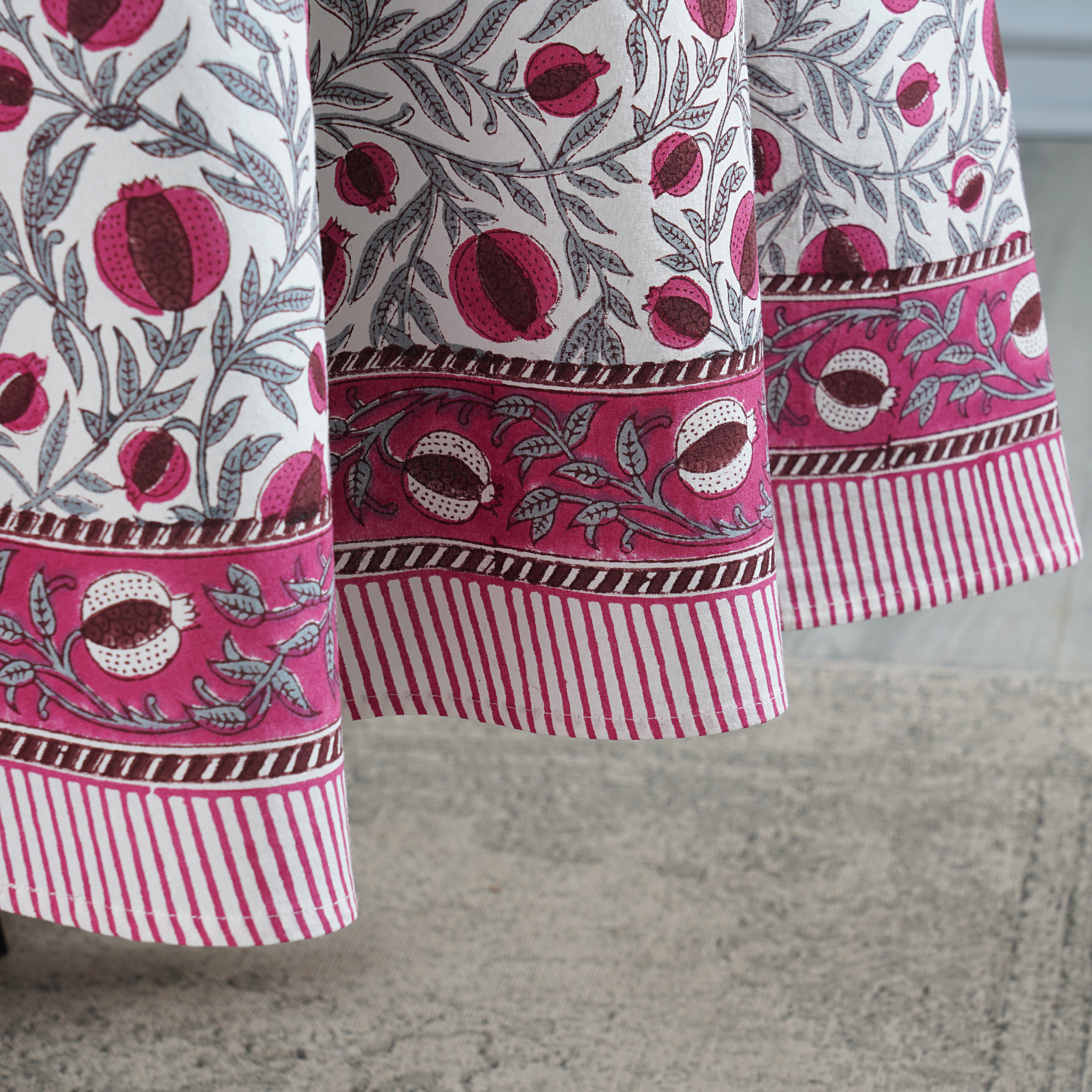 Close-up of a fabric with pomegranate pattern on a neutral background