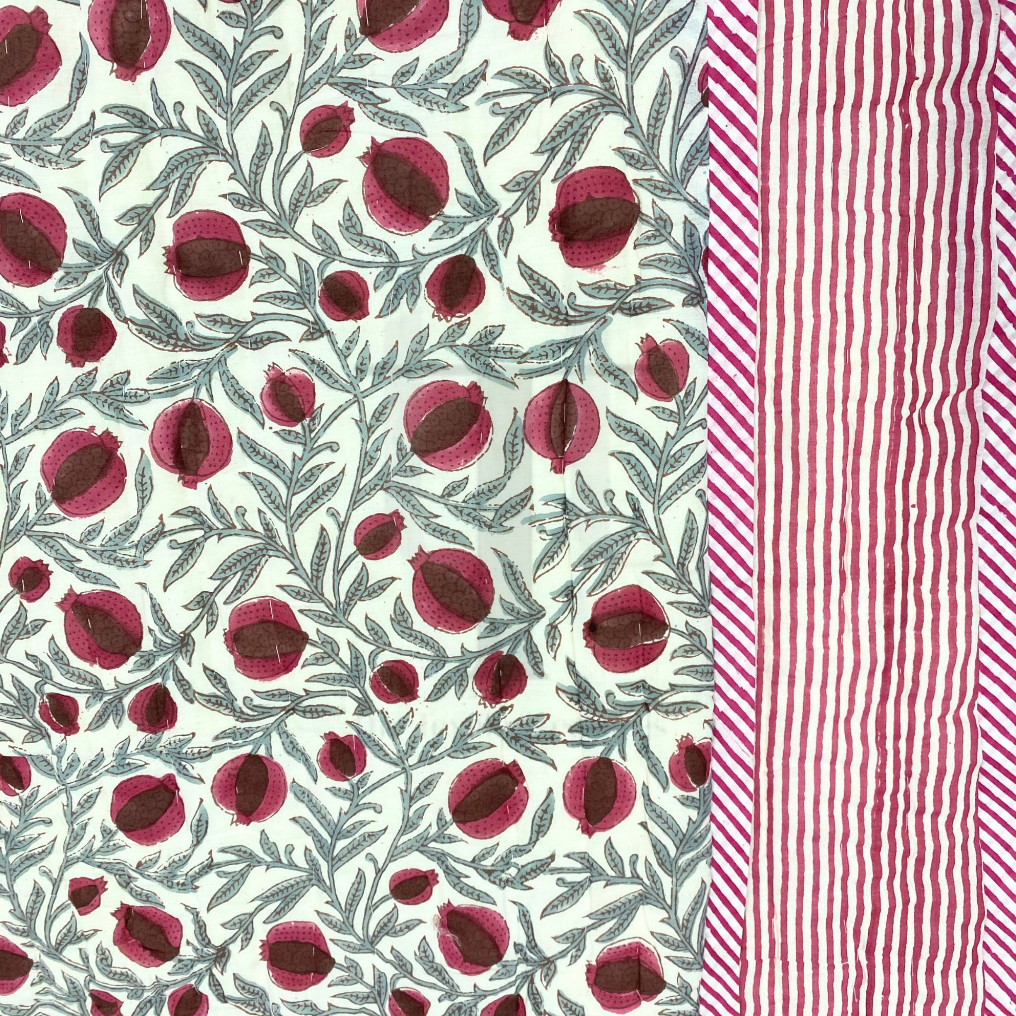 Fabric with red floral pattern on one side and red and white striped pattern on the other