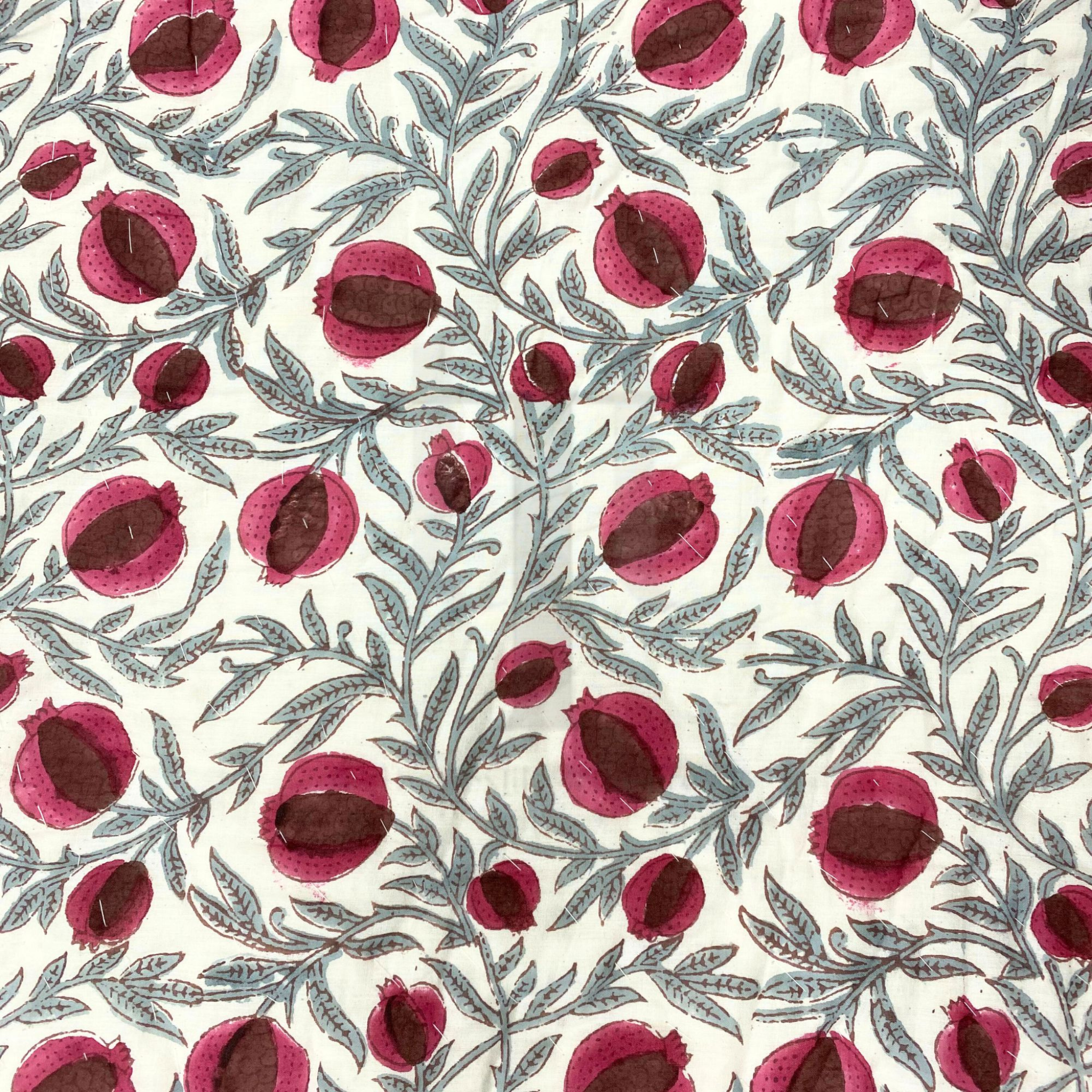 Pattern of red pomegranate fruits on a white background