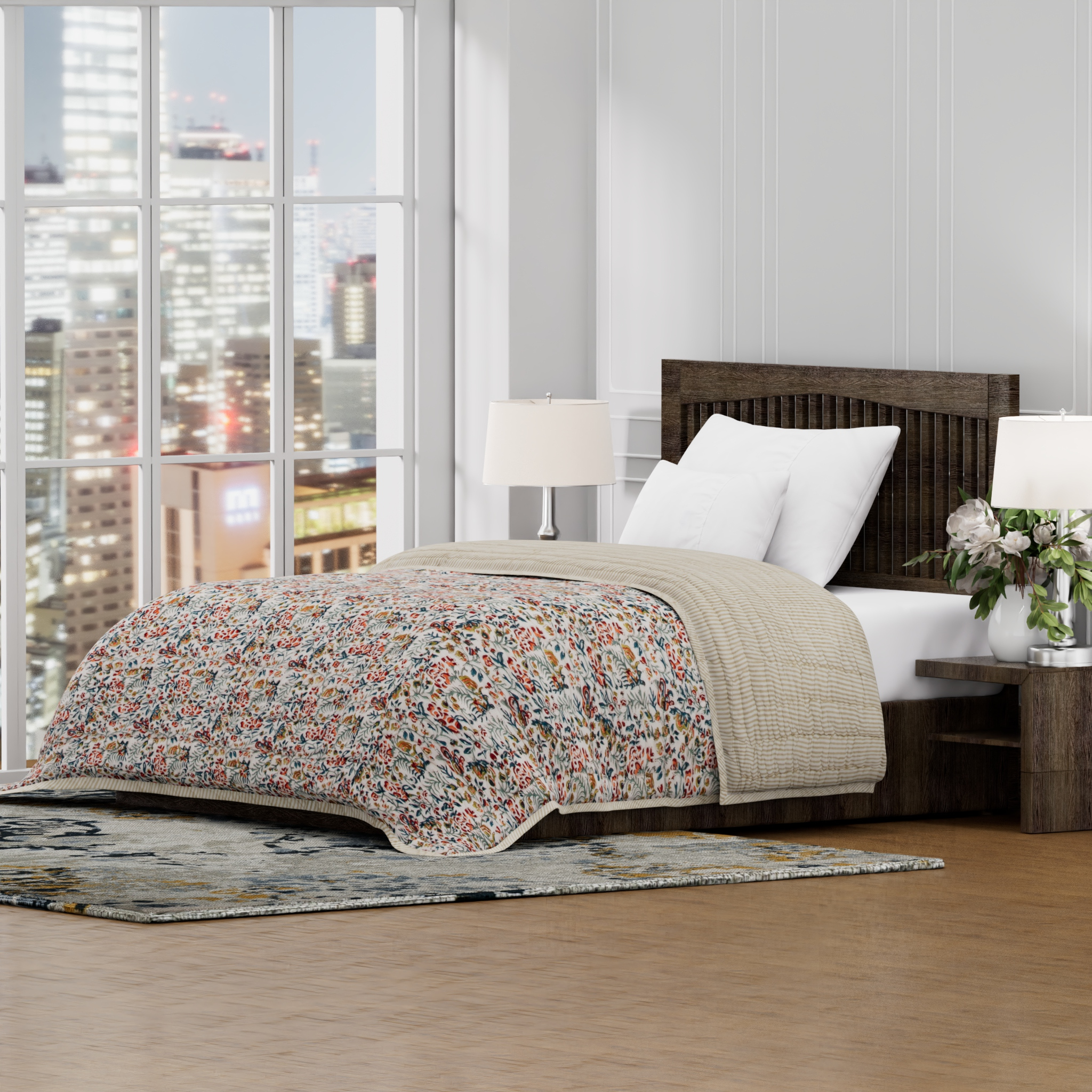 Bedroom with floral quilt, wooden headboard, and city view