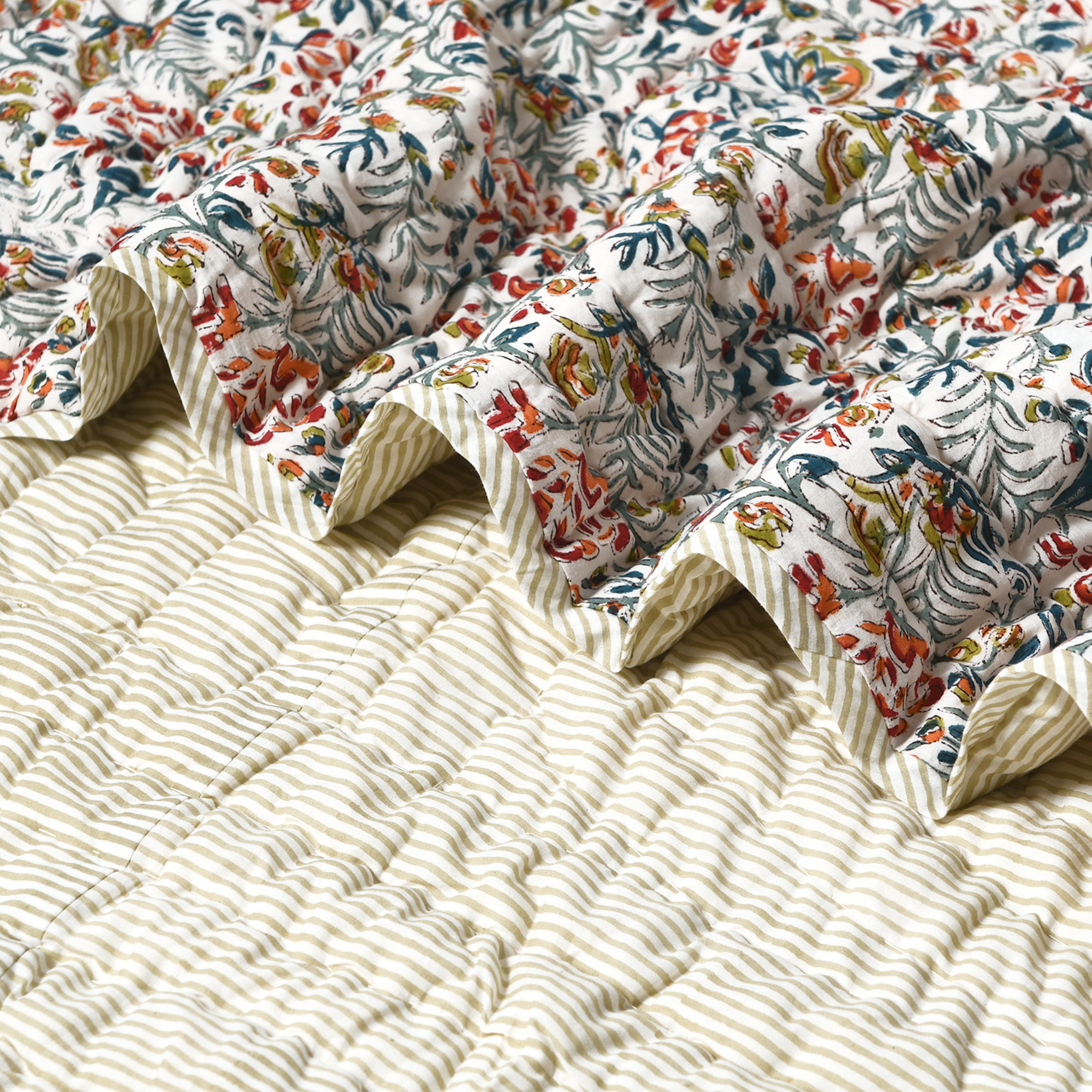 Floral patterned quilt on a textured beige surface