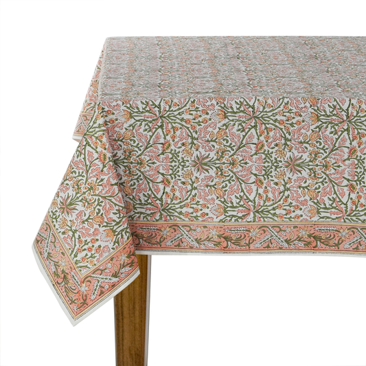 Floral patterned tablecloth on a wooden table with a white background