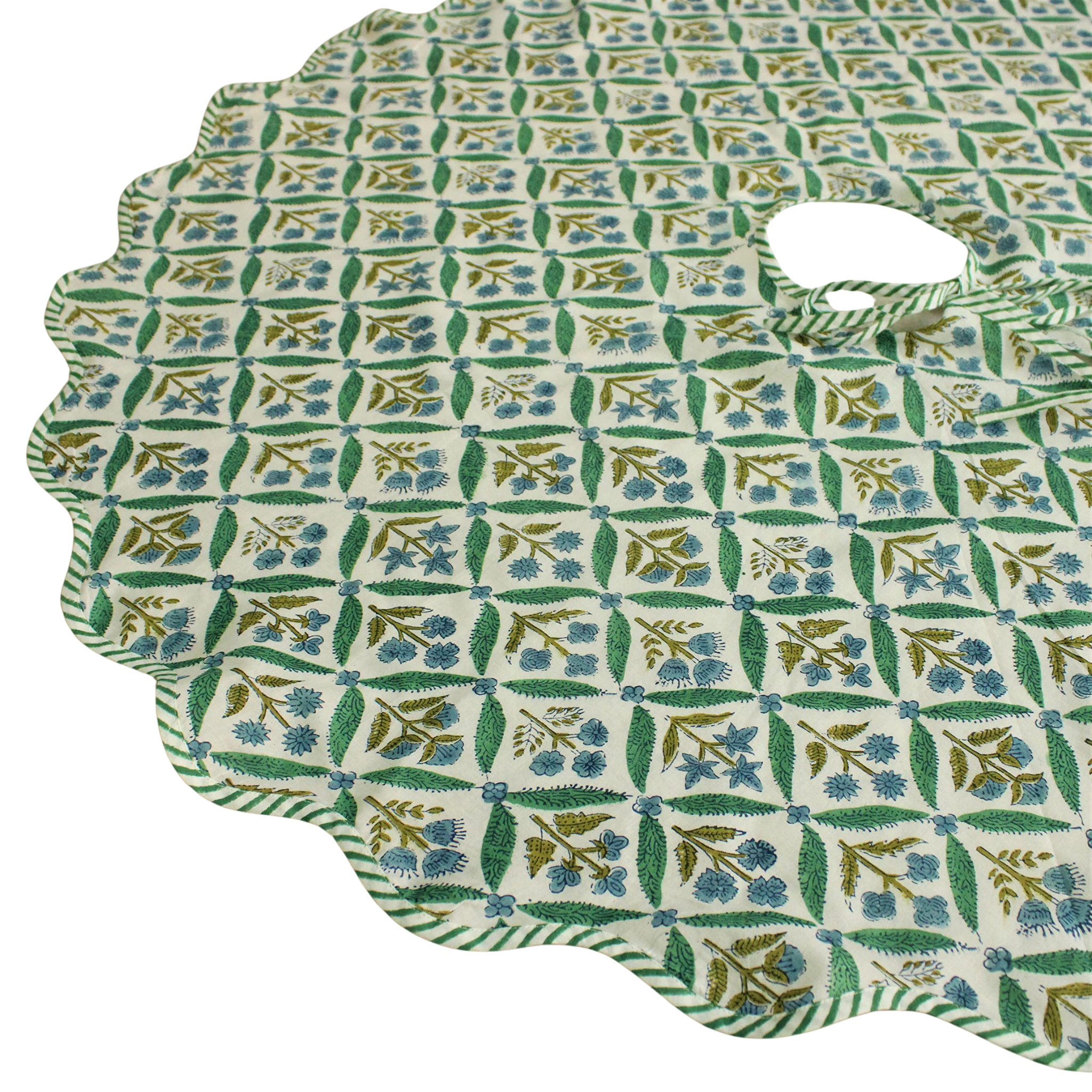 Green and white patterned fabric with a scalloped edge on a white background