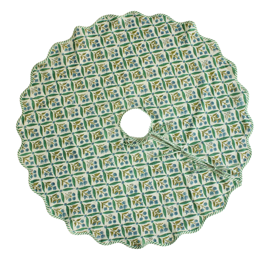 Decorative green and blue patterned tree skirt on a white background