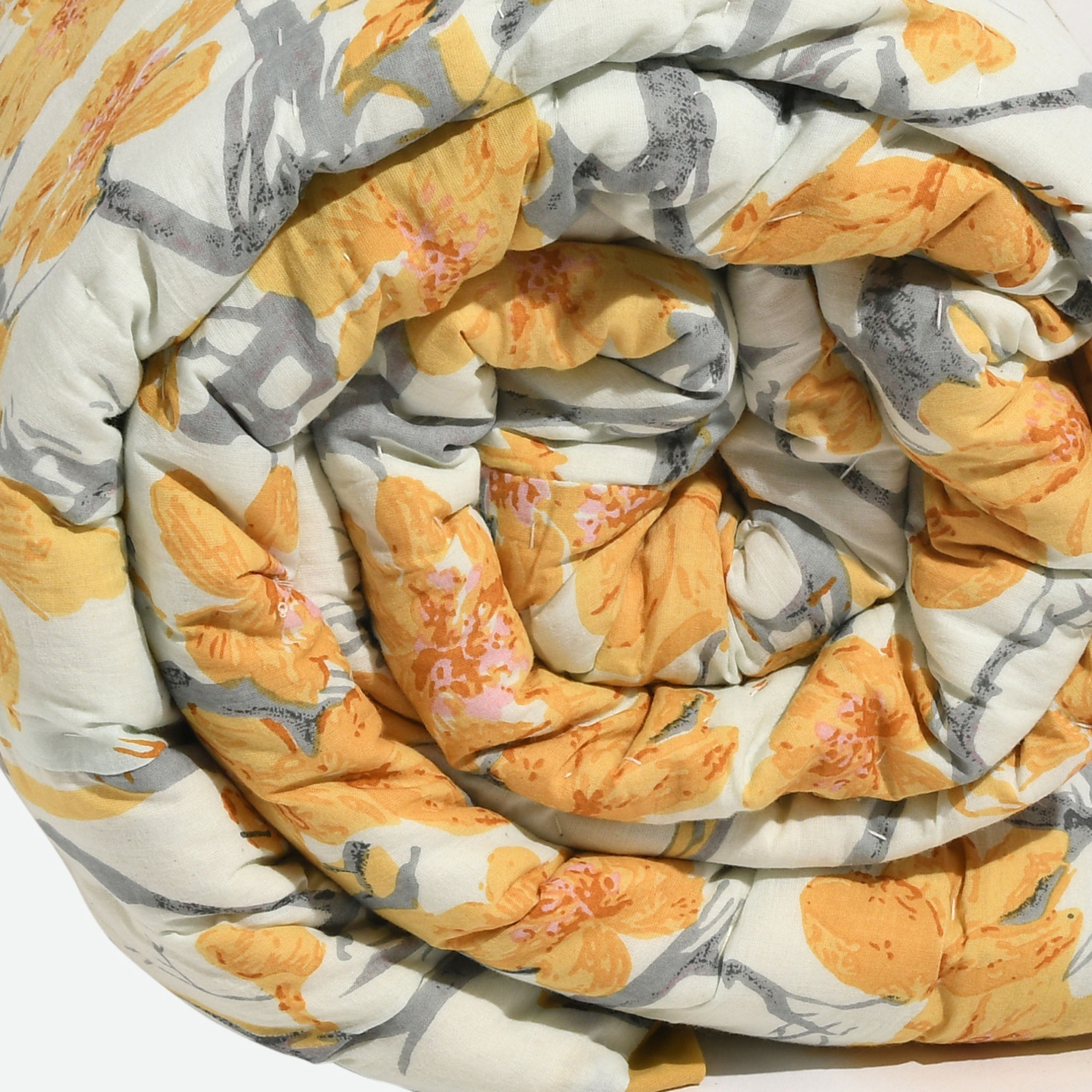 Coiled blanket with floral pattern on a white background