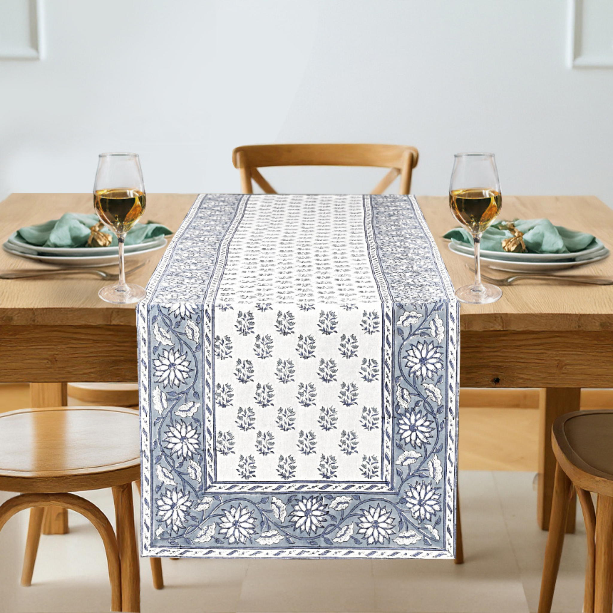 Table setting with a decorative table runner on a wooden table.