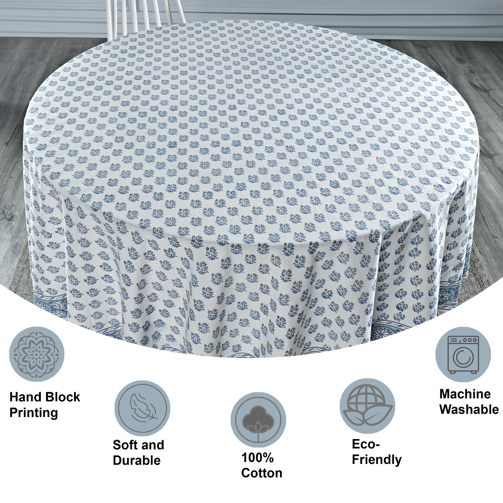 Round tablecloth with floral pattern on a wooden floor, featuring icons and text about material and care.
