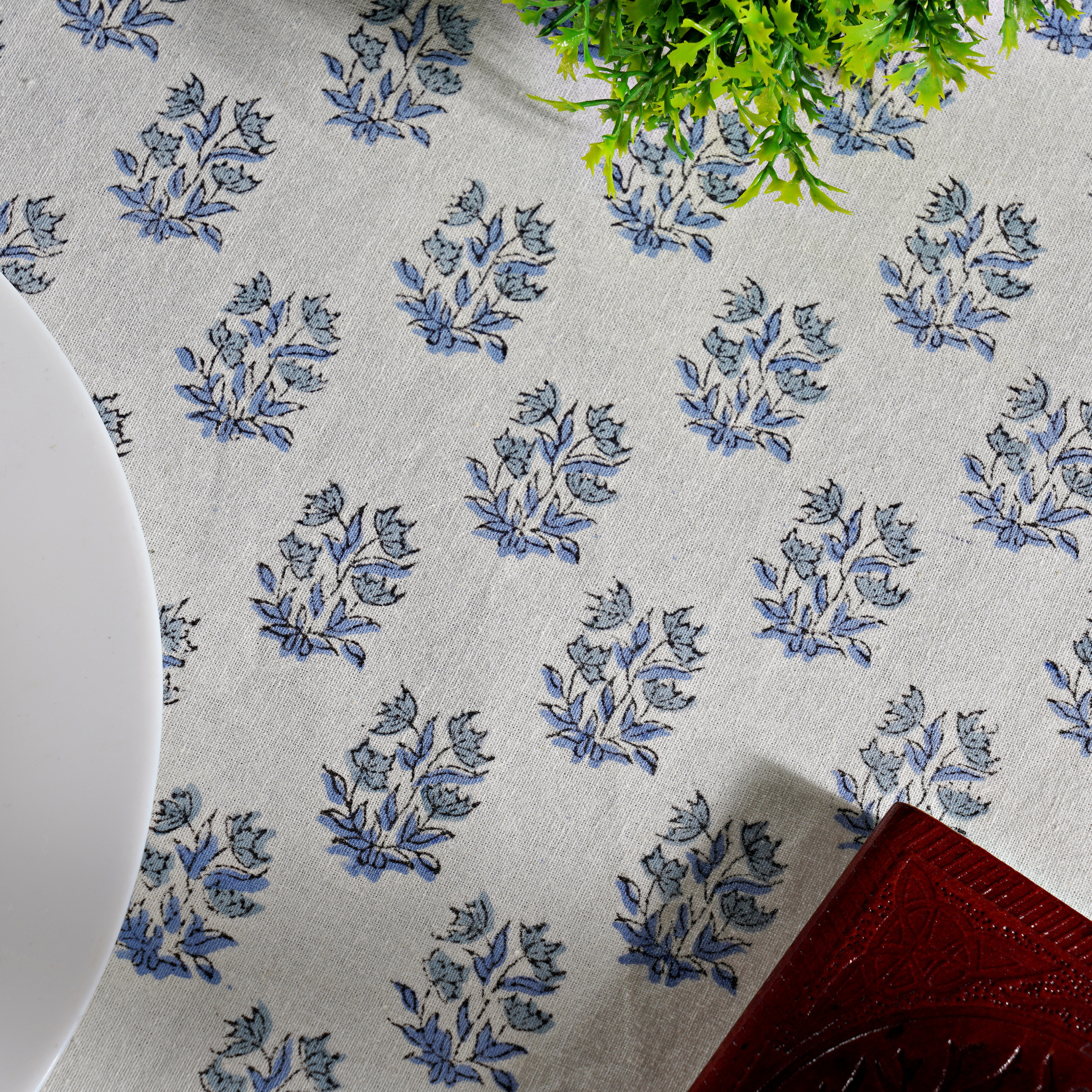Tablecloth with blue floral pattern on a white background