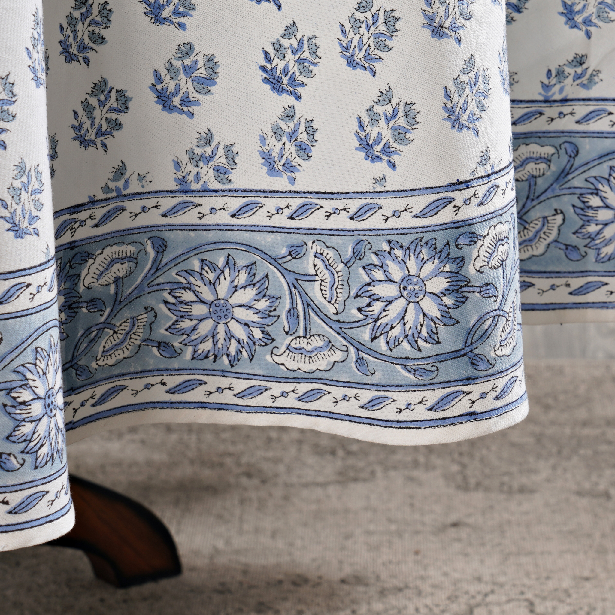 Blue and white floral patterned fabric on a textured surface