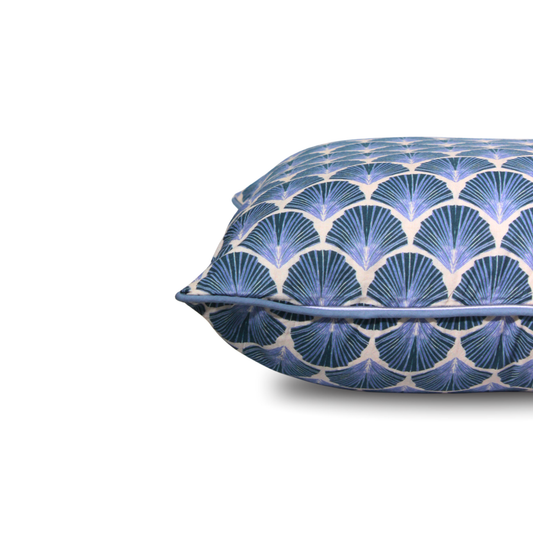 Decorative pillow with blue and white geometric pattern on a white background