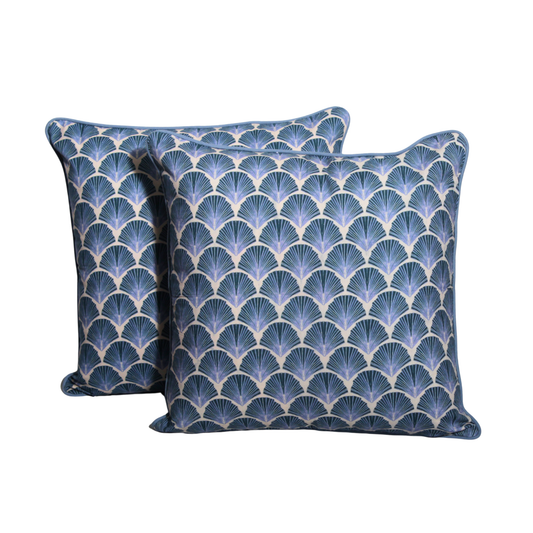 Two blue patterned pillows on a white background