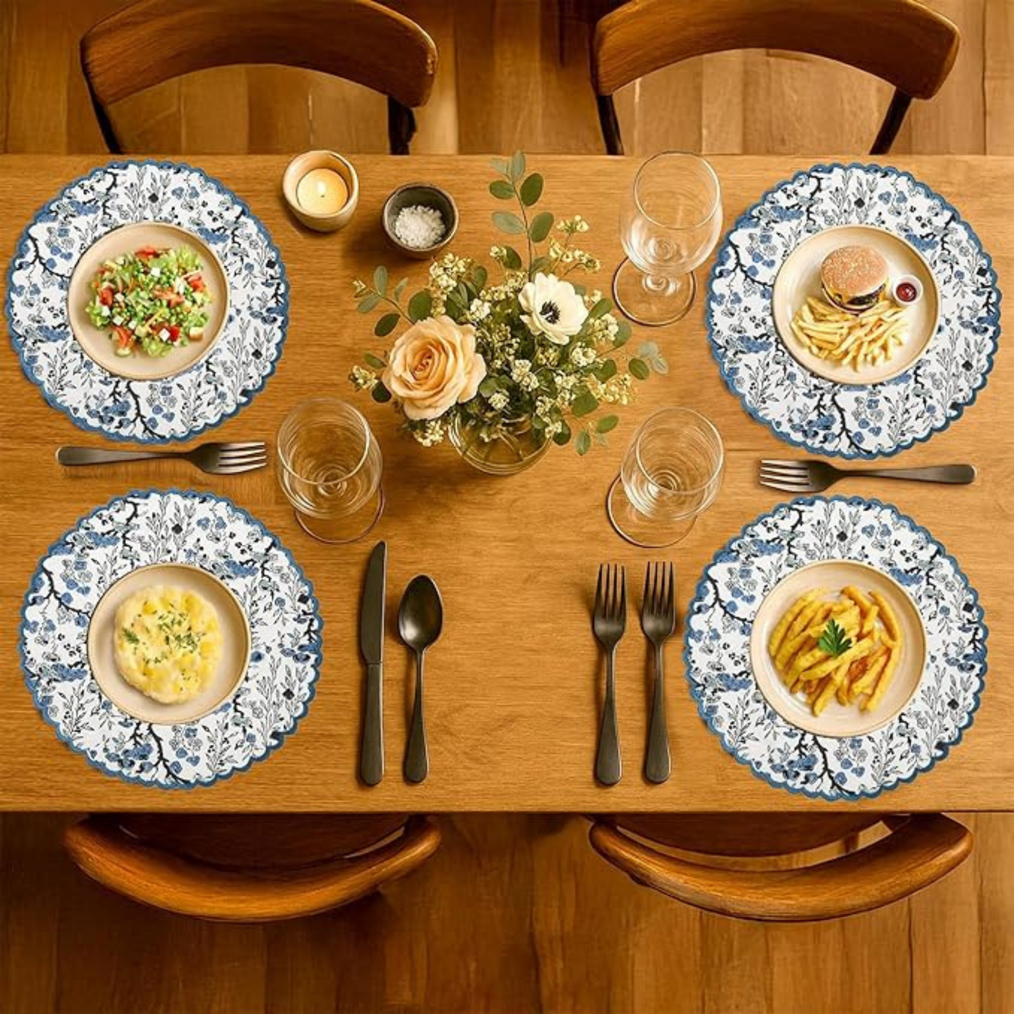 Dining table set with plates, cutlery, and a centerpiece on a wooden table.