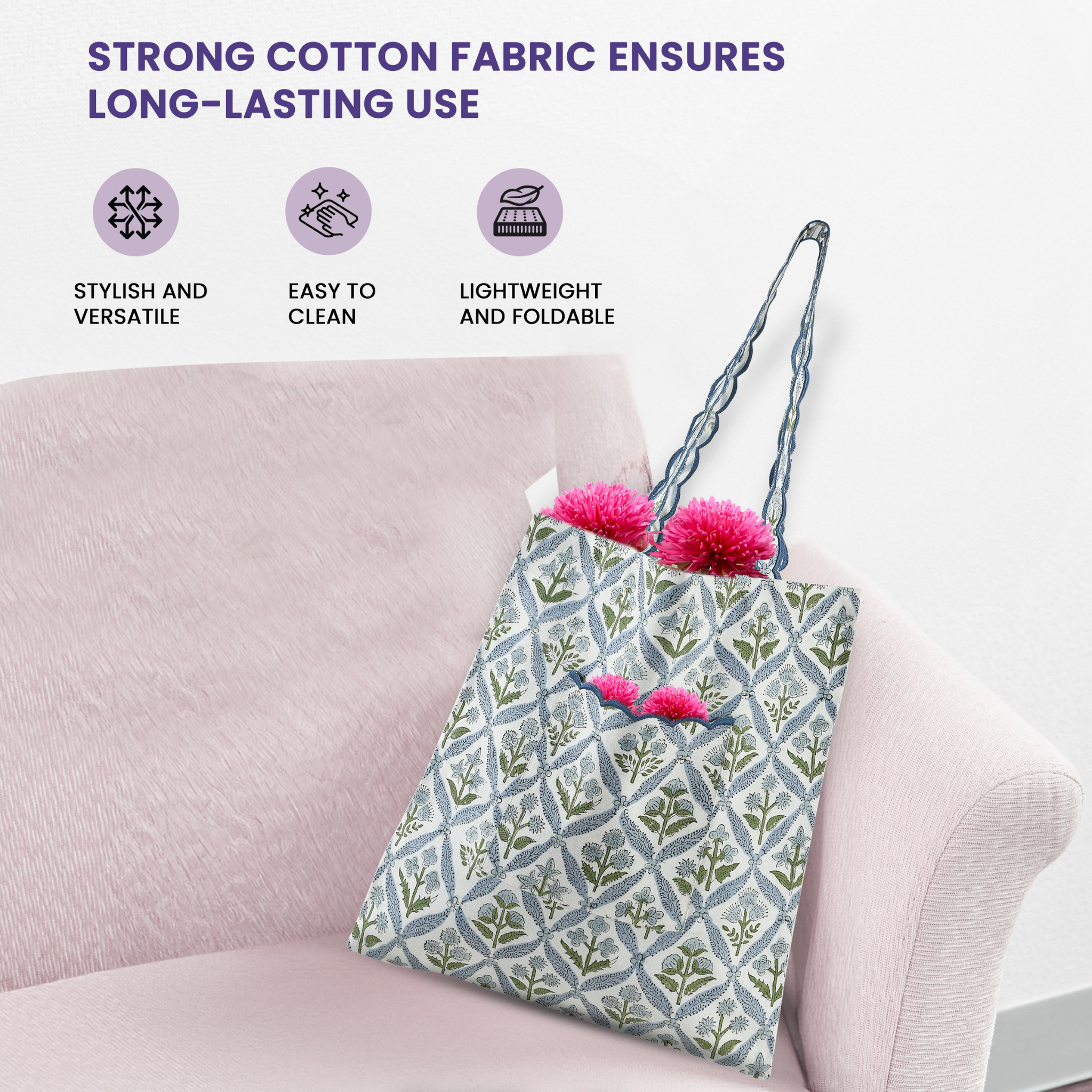 Floral-patterned tote bag with pom-poms on a pink couch, featuring text about strong cotton fabric.