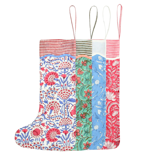 Colorful patterned christmas stockings with floral and striped designs on a white background