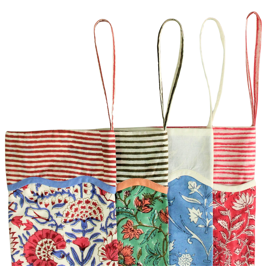 Colorful patchwork stocking with floral and striped patterns on a white background