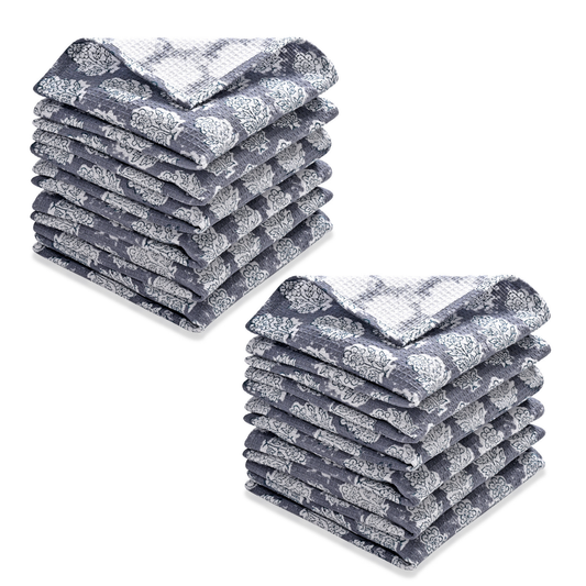 Two stacks of gray and white patterned towels on a white background